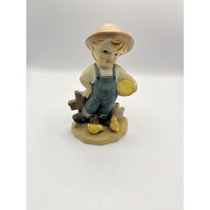 Vintage porcelain figurine of a Farmer‎ Boy Feeding the Chickens